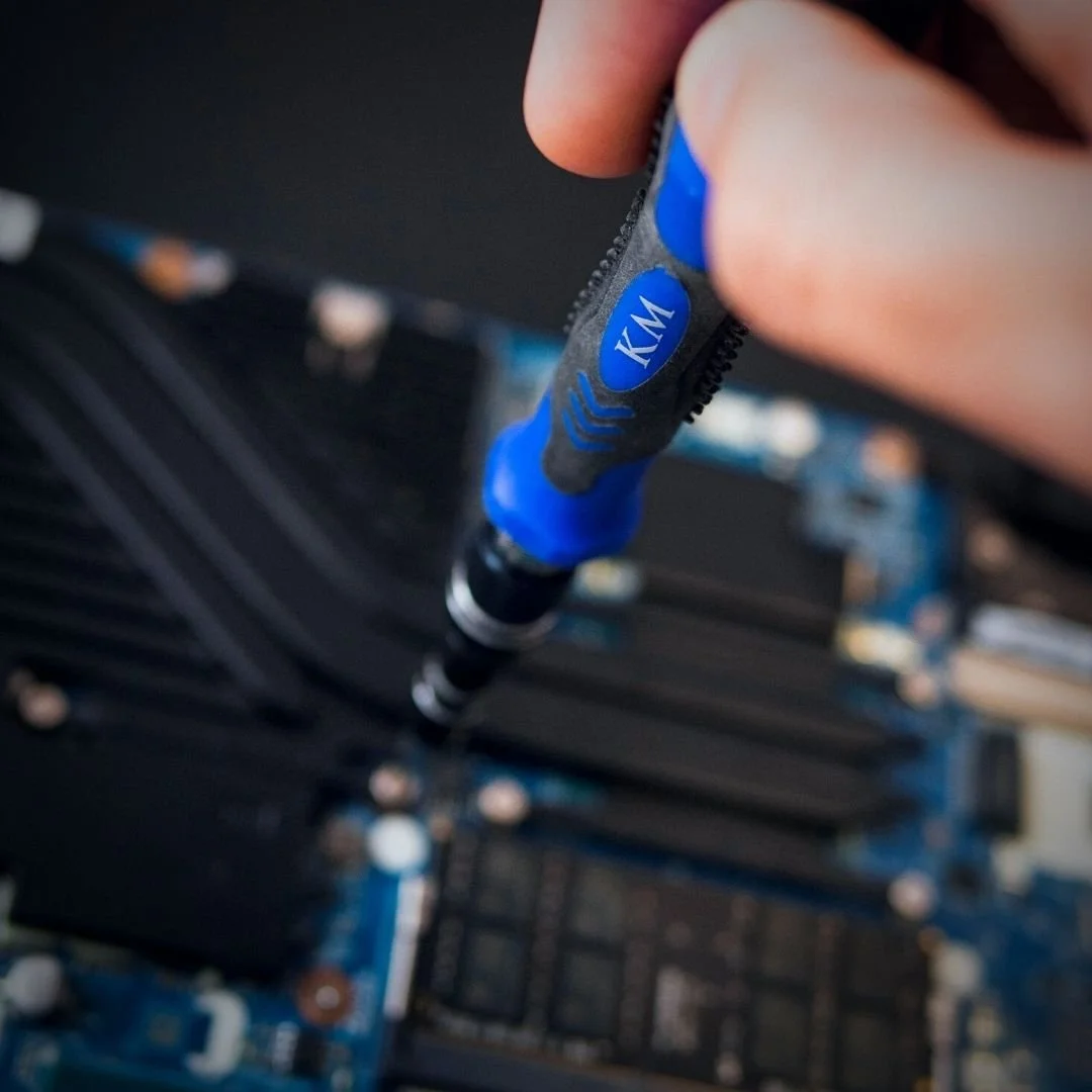 KOMBO-01 screwdriver in use on laptop motherboard